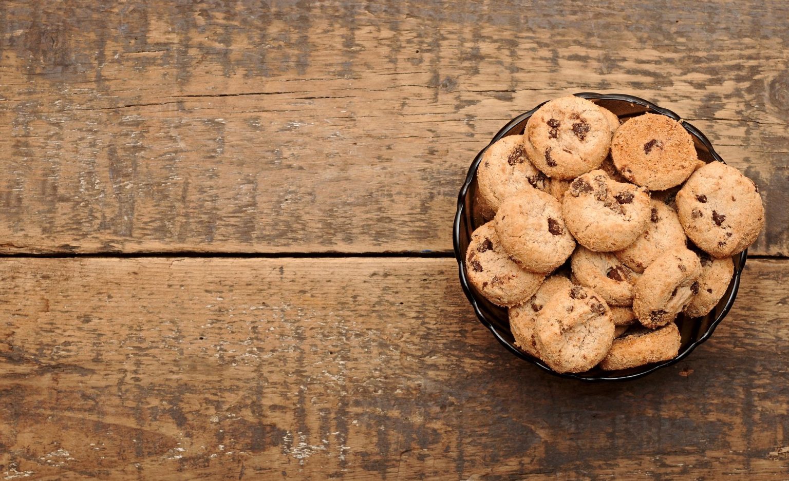 Chocolate chip cookies in a cup on wooden table Picture